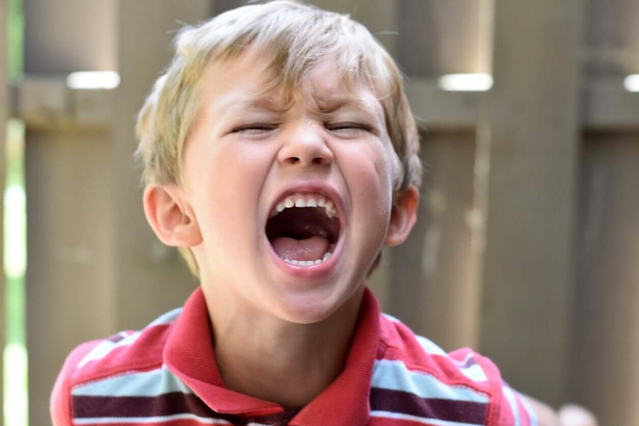 A young boy having a temper tantrum.
