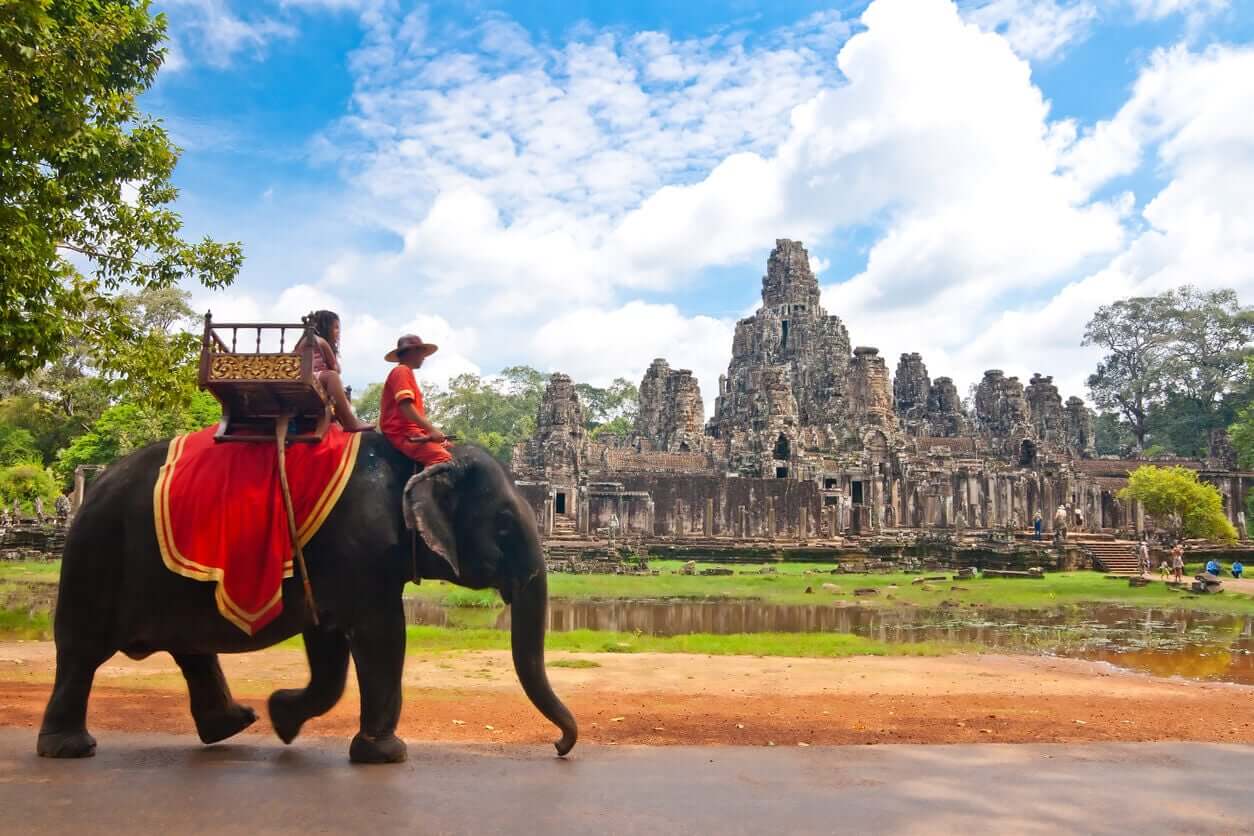 A man riding an elephant in Cambodia.