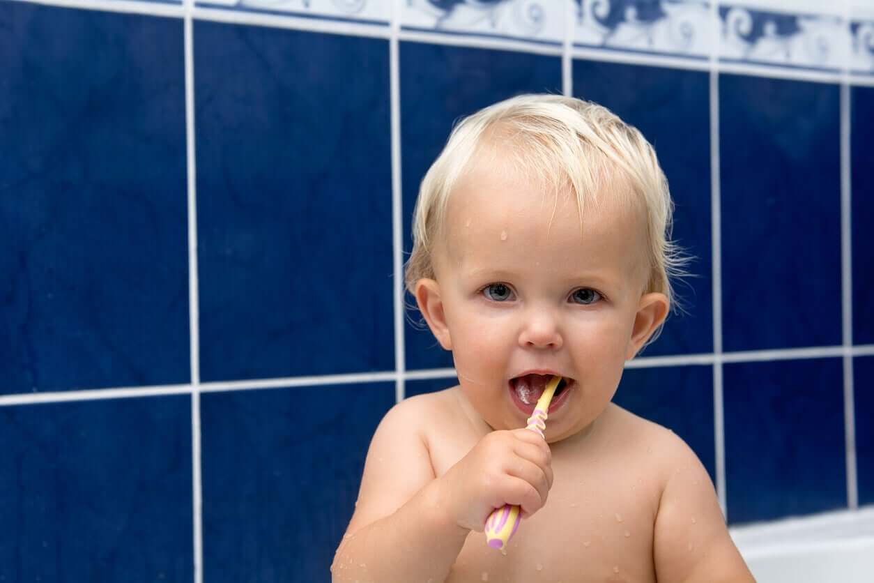 A baby boy brushing his teeth.