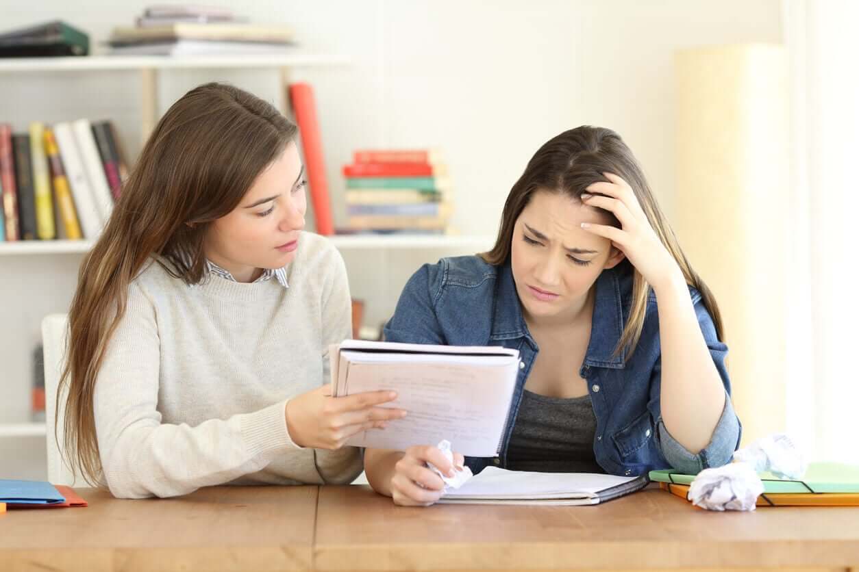 A mother trying to help her frustrated teen daughter with her homework.