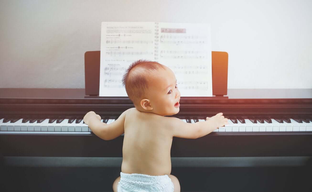 A baby playing the piano.