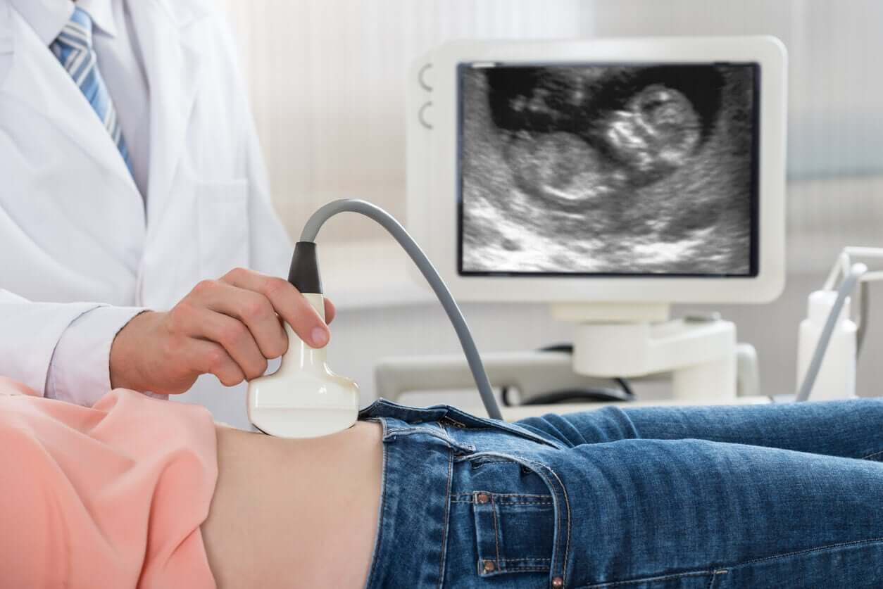 A doctor performing an pregnancy ultrasound.