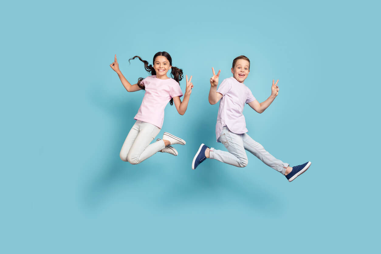 Two children jumping in the air.