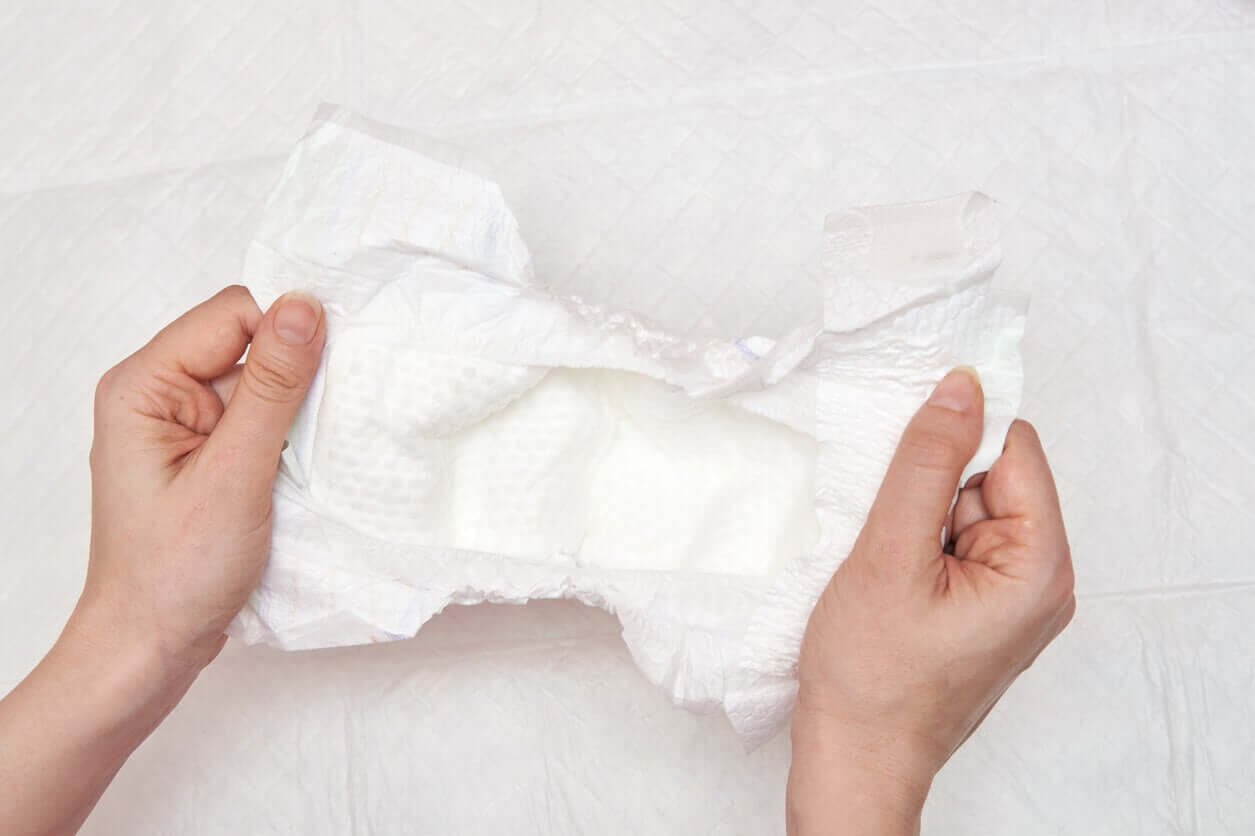 A woman preparing a clean diaper.