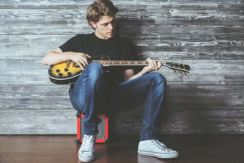 A teenage boy playing an electric guitar.