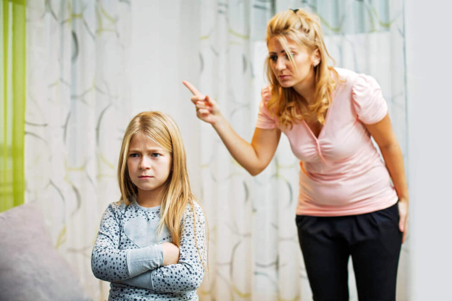 A mother scolding her young daughter.