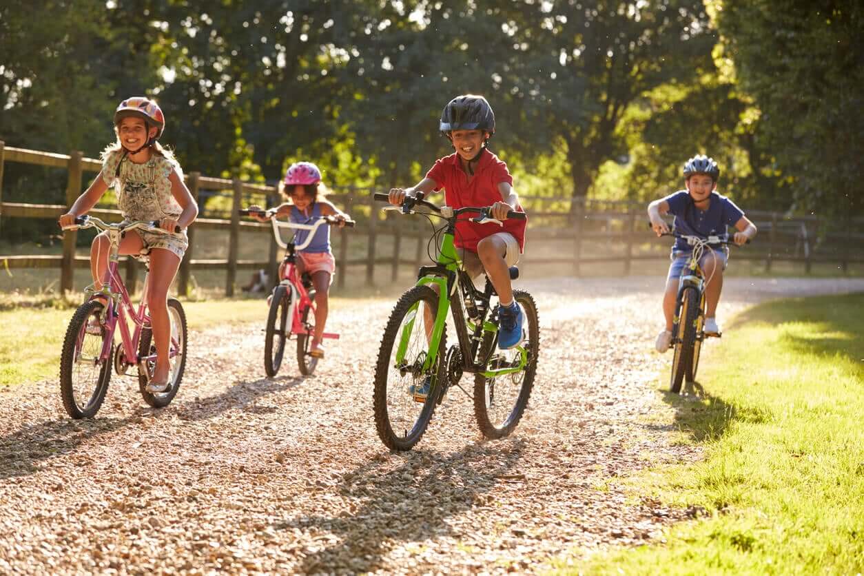 Children riding bikes in the country.