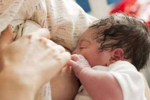 A tiny newborn breastfeeding.