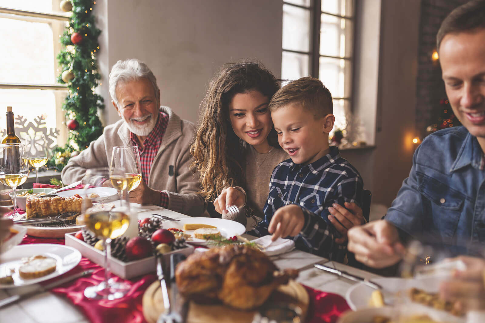 Extended family sitting down for a Christmas meal.