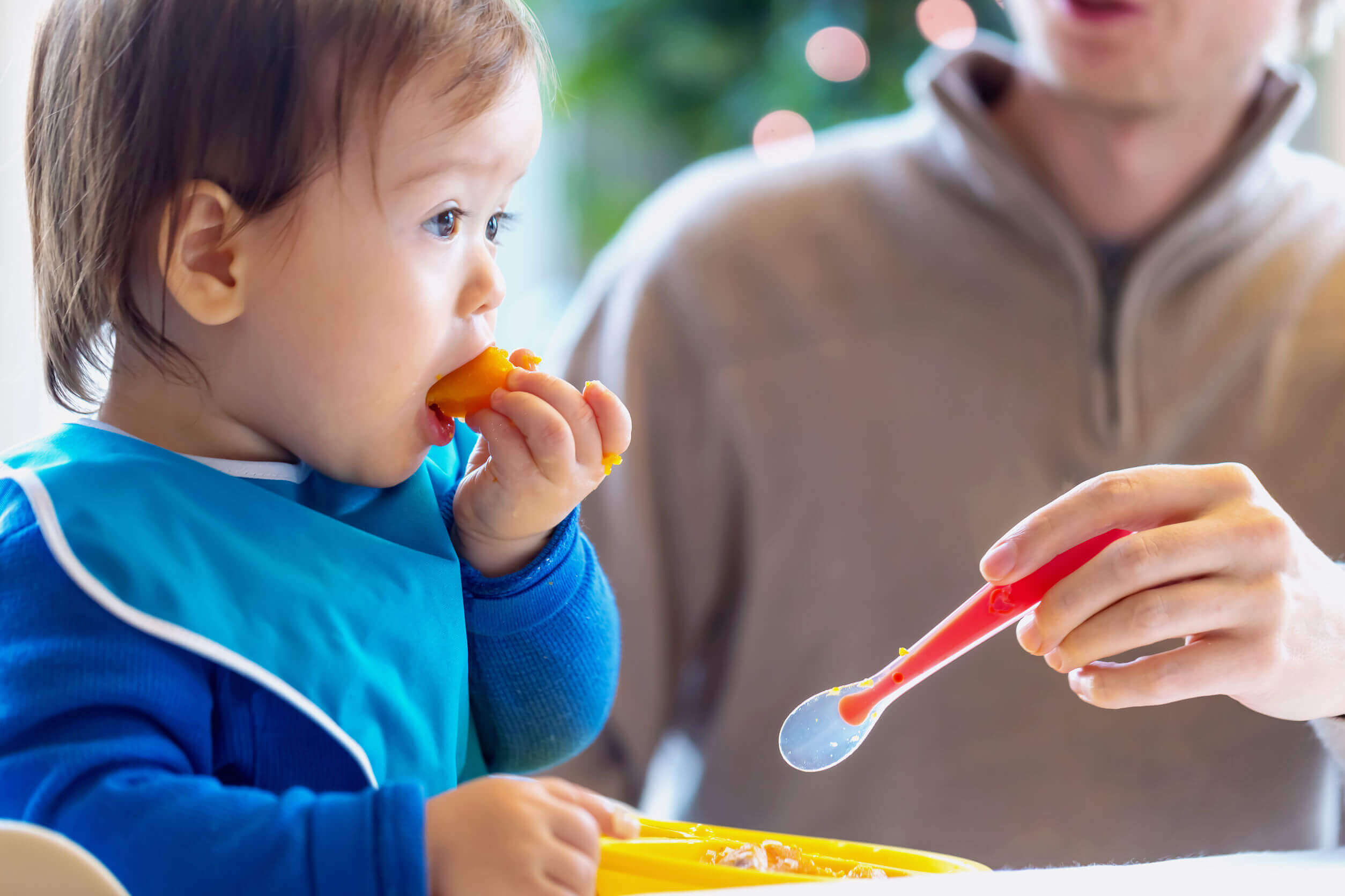 A small child eating fruit.