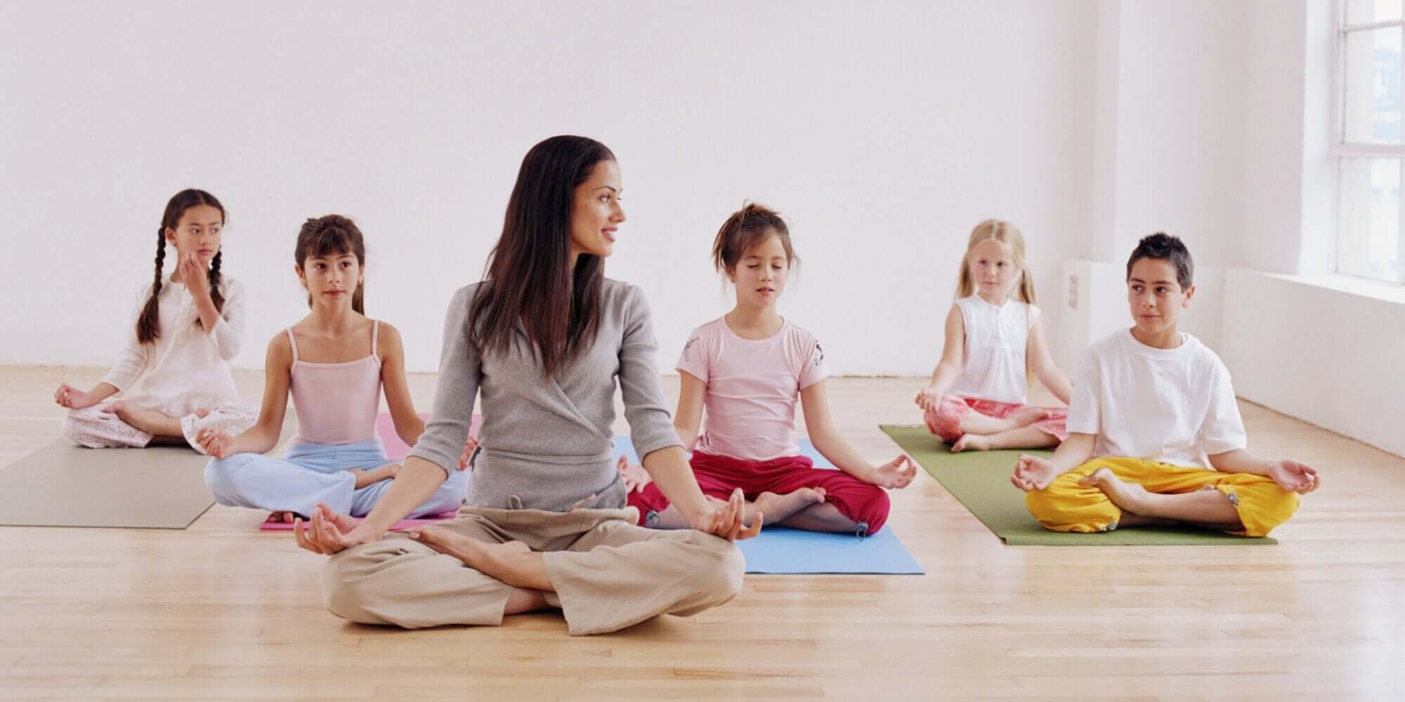 Children meditating while in the frog position.