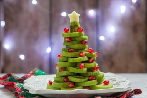 A christmas tree made of fruit.