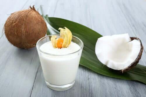 A class of coconut milk and an open coconut.