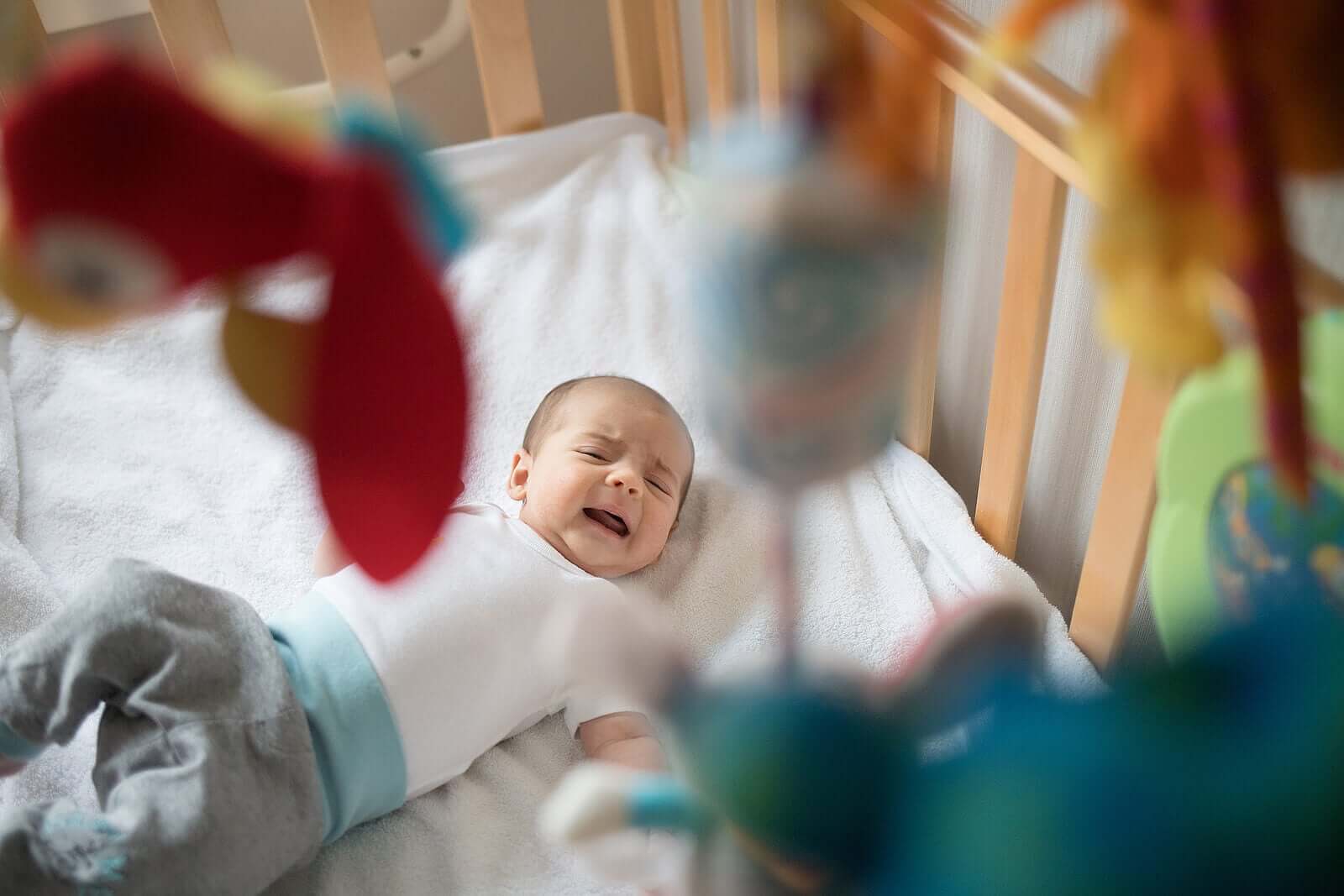 A baby crying in his crib.