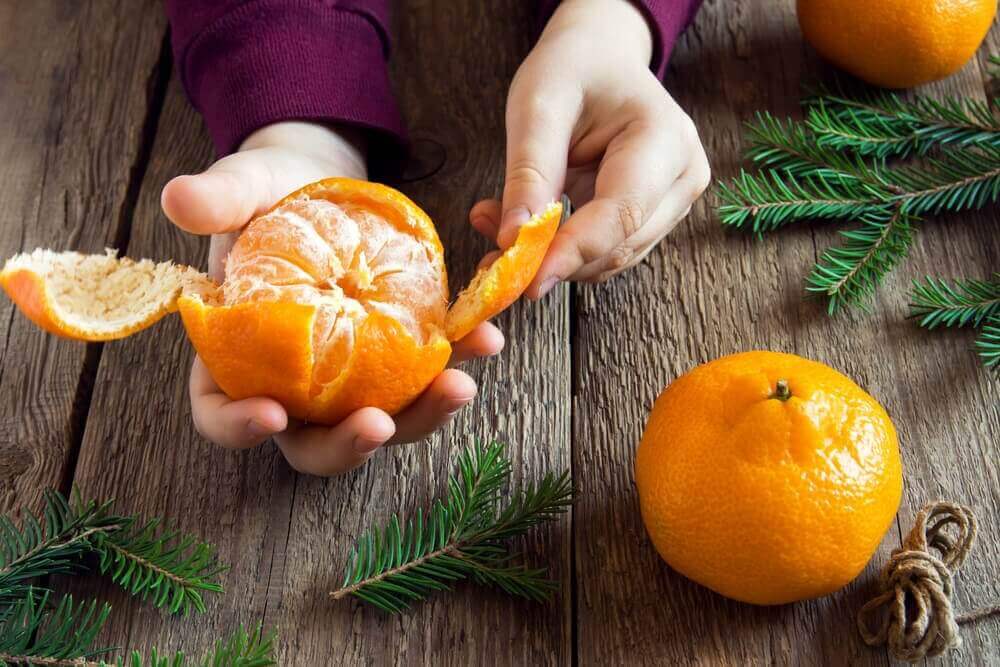 A woman peeling tangerines.
