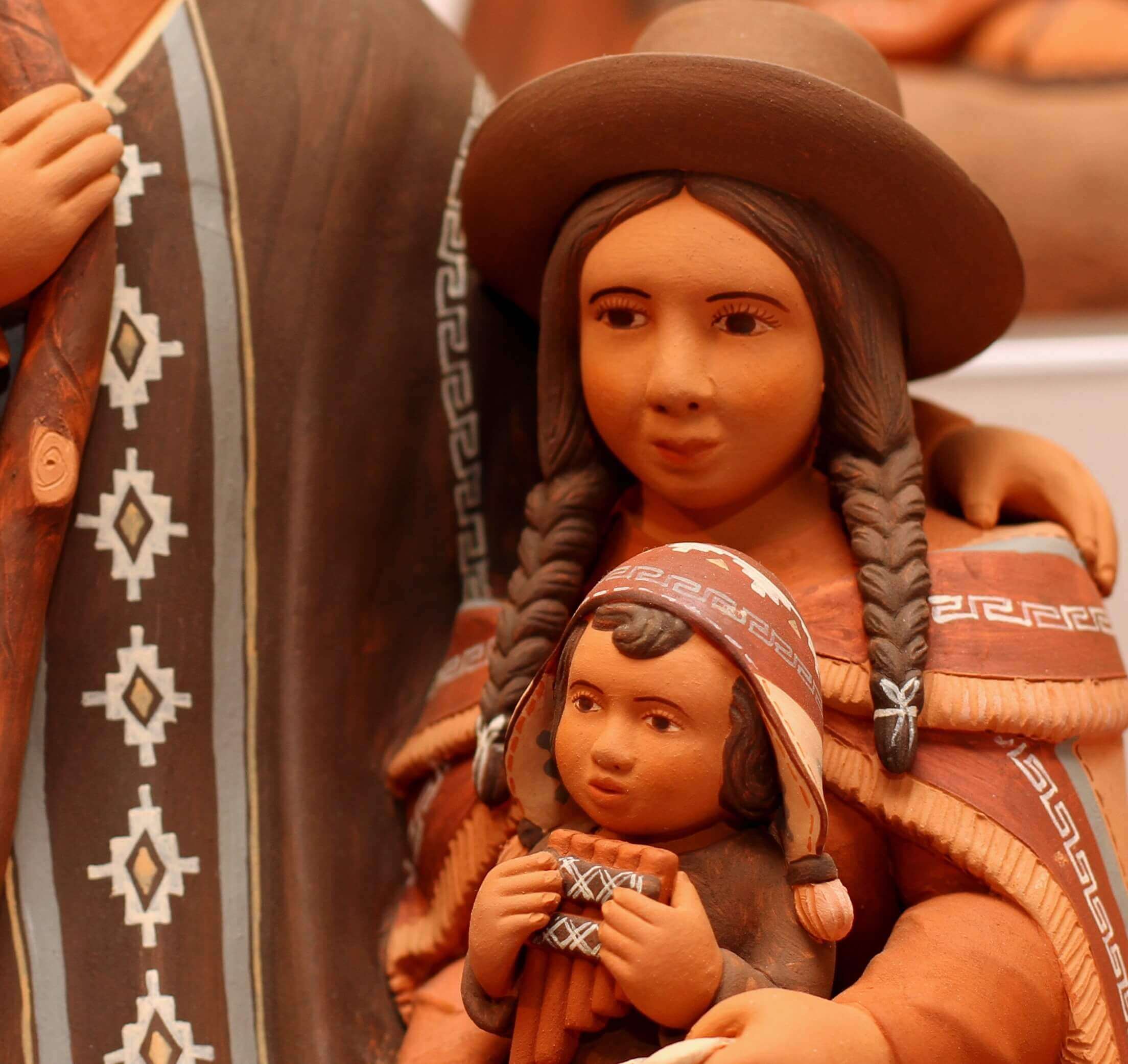 A terra cotta figurine of a indigenous South American family.