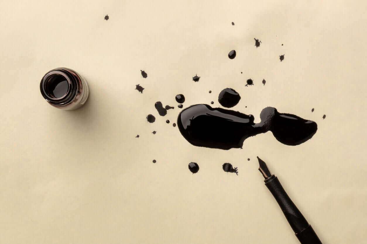 Black ink splattered on a paper.