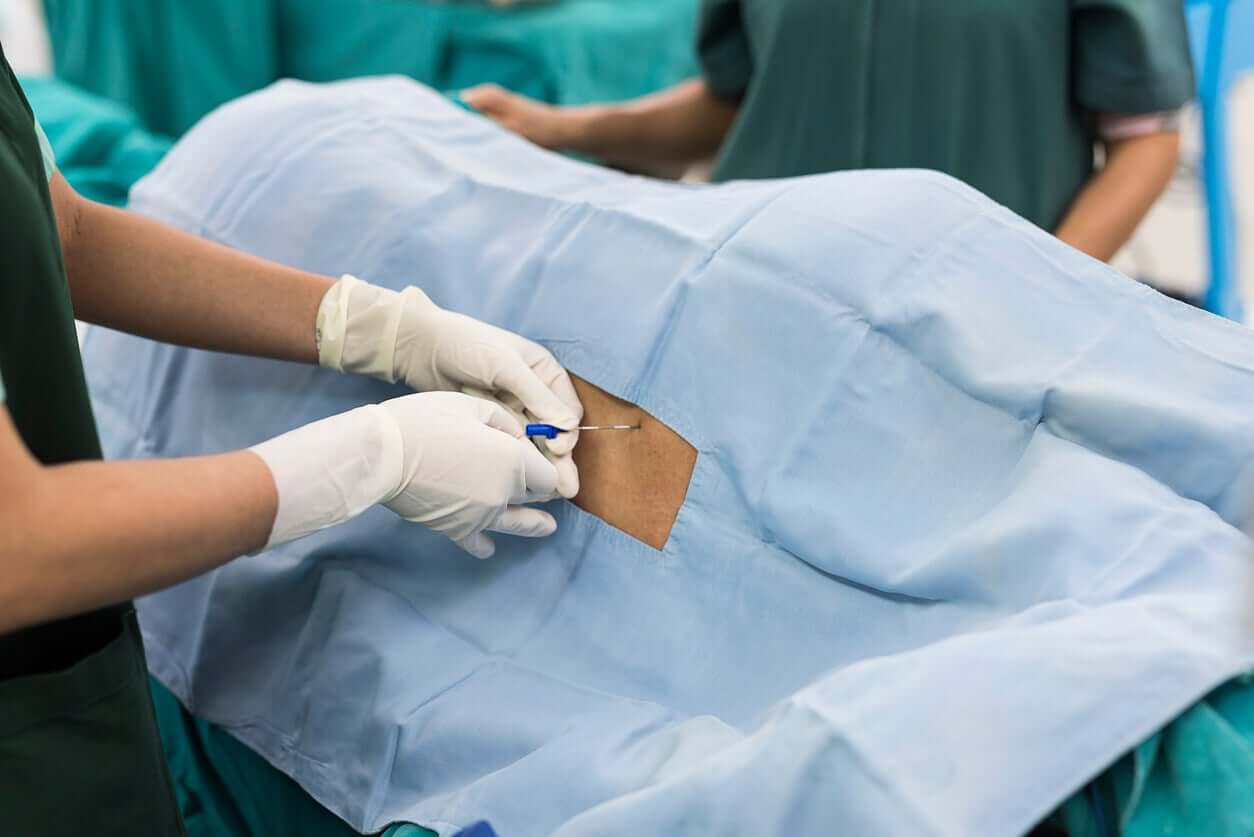 A doctor applying an epidural.