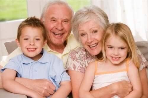 Grandparents smiling for a picture with their grandchildren.