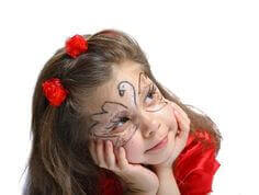 A girl with her face painted with a swan.