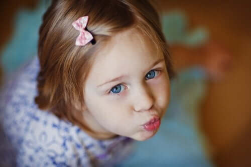 A young girl puckering her lips.