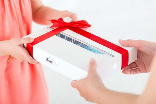 A child receiving an iPad as a gift.