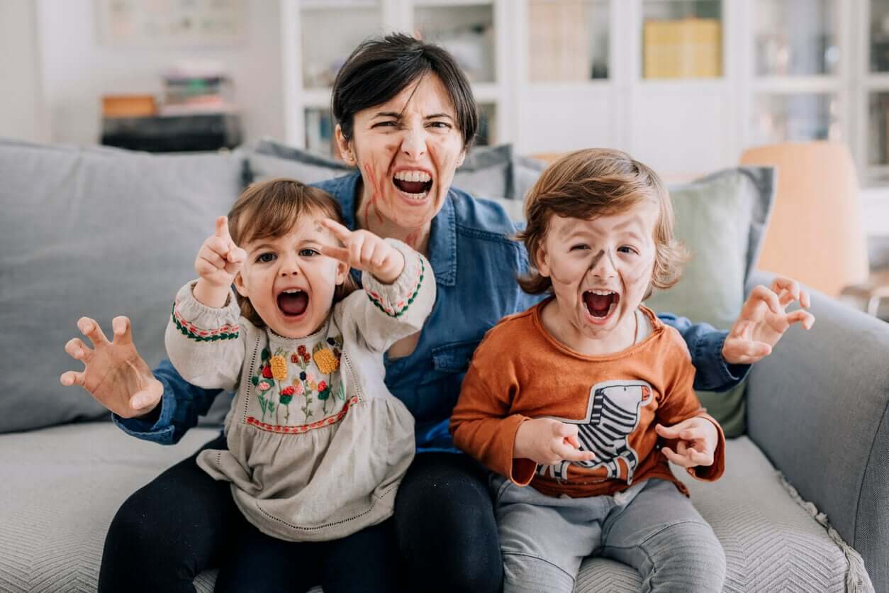 A mother and her children wearing facepaint and pretending to be animals.
