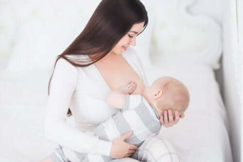 A woman breastfeeding her baby boy.