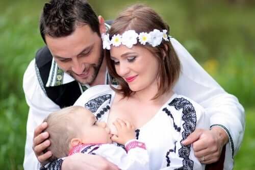 A couple admiring their baby as he breastfeeds.