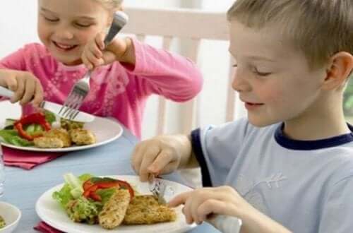 Children eating baked fish.