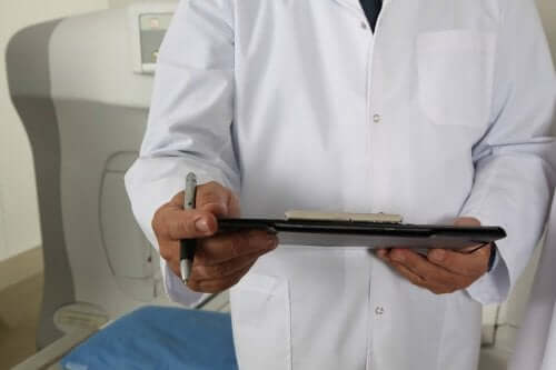 A doctor looking at a patient's chart.