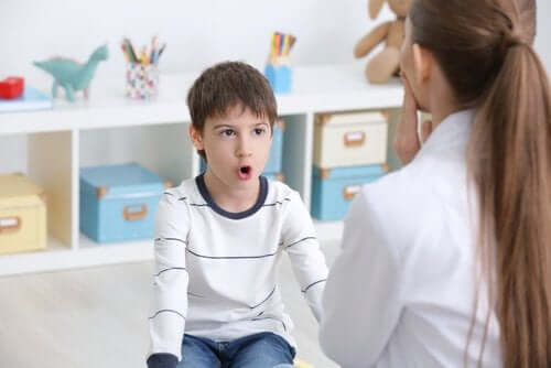 A boy with a speech therapist.