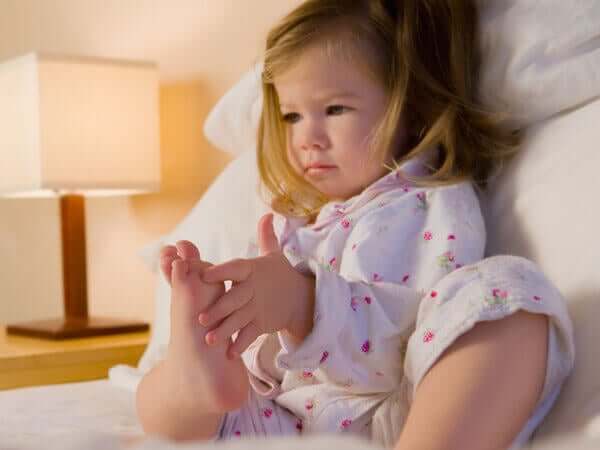 A toddler sitting in a bed.