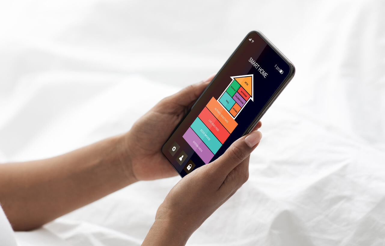 A woman using a home security app on her phone.