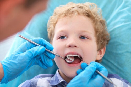A dentist examining a young boy's teeth.