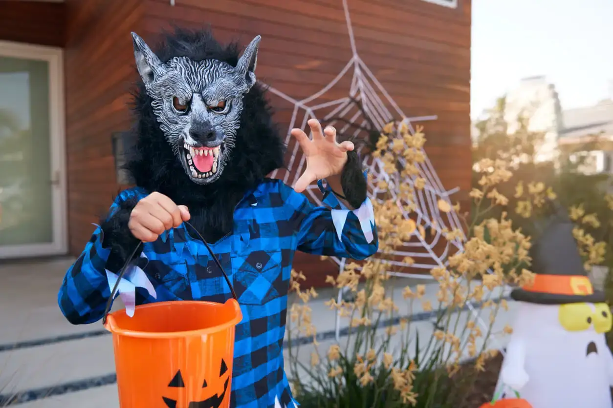A child wearing a werewolf costume to go trick or treating.