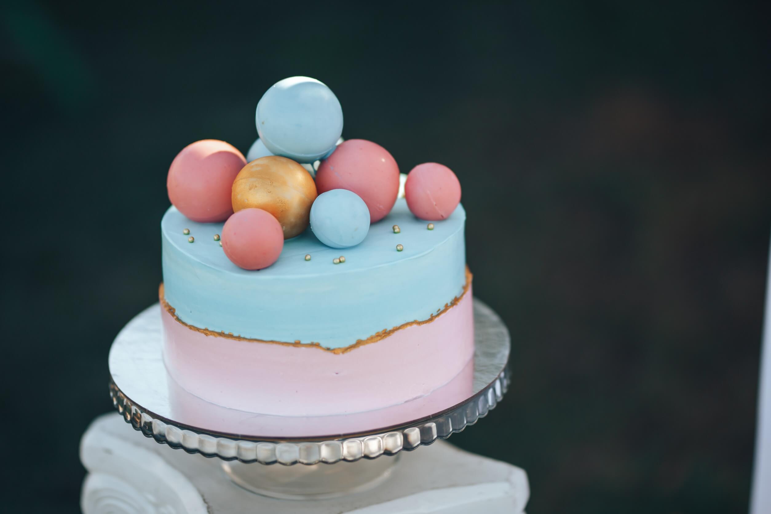 A boho chic gender reveal cake.